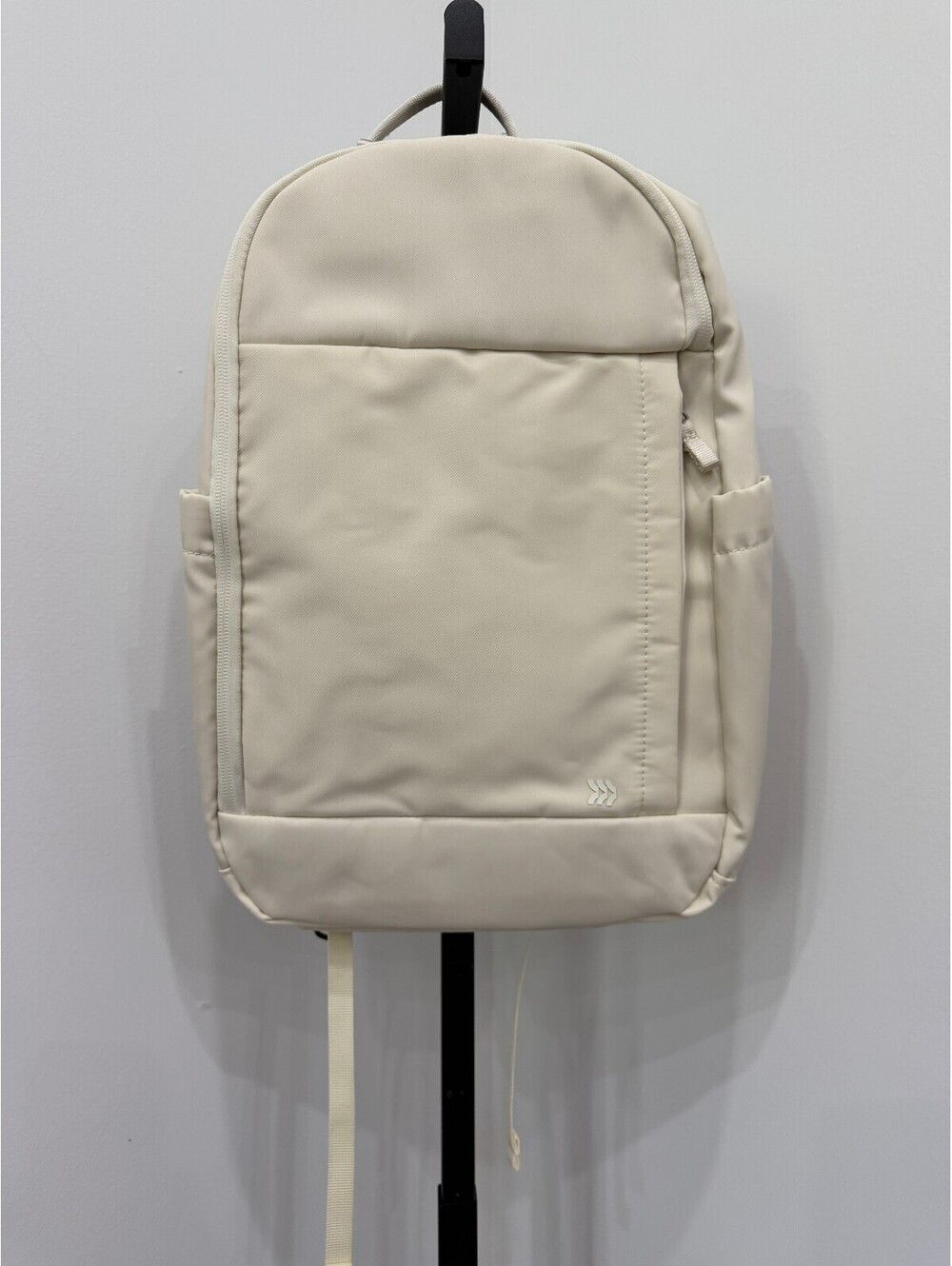 All in Motion Minimalist Cream Backpack with Side Pockets and Padded Straps